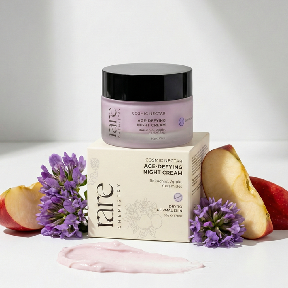 Cosmetic jar and packaging of 'rare Chemistry' age-defying night cream with apples and flowers on a light background