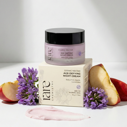 Cosmetic jar and packaging of 'rare Chemistry' age-defying night cream with apples and flowers on a light background