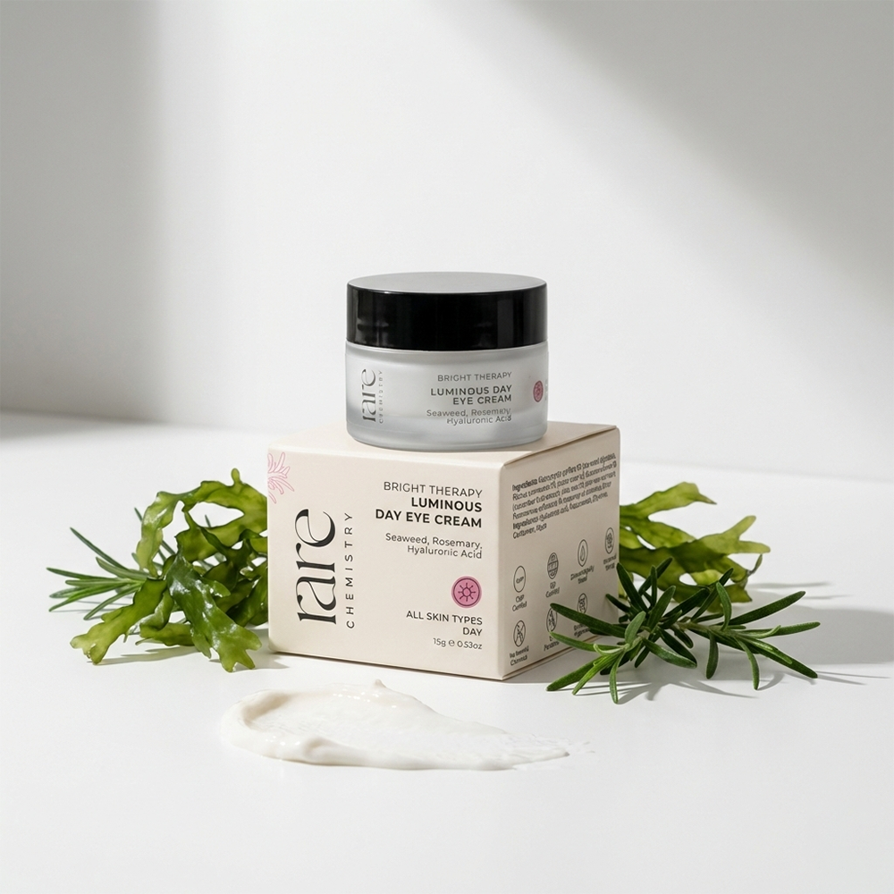 Luminous Day Eye Cream jar and box with green leaves on a white background