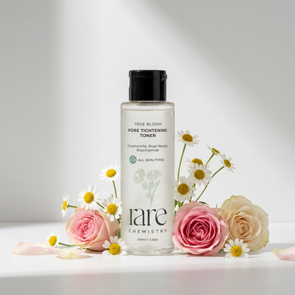 Bottle of 'rare chemistry' toner with flowers on a light background