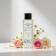 Bottle of 'rare chemistry' toner with flowers on a light background
