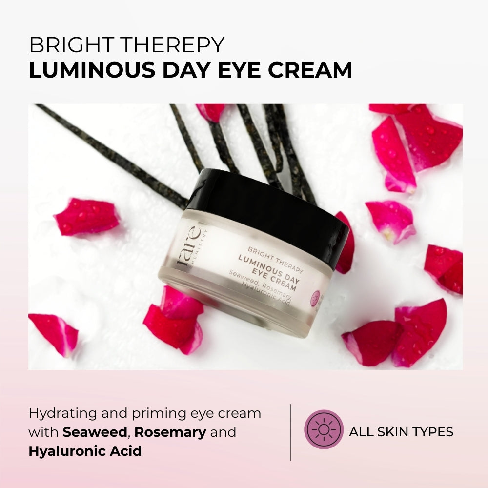 Luminous Day Eye Cream with Seaweed, Rosemary, and Hyaluronic Acid on a white background with pink rose petals.