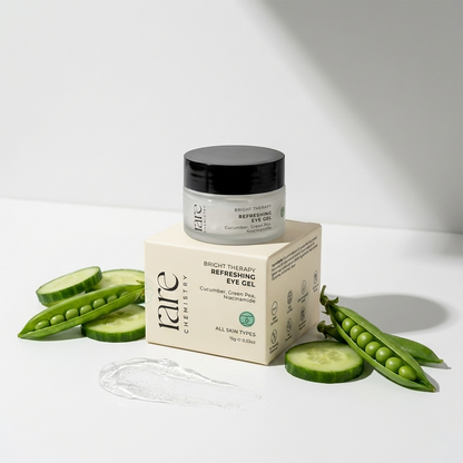 Rare chemistry eye gel jar with packaging, surrounded by cucumber slices and green peas on a white background