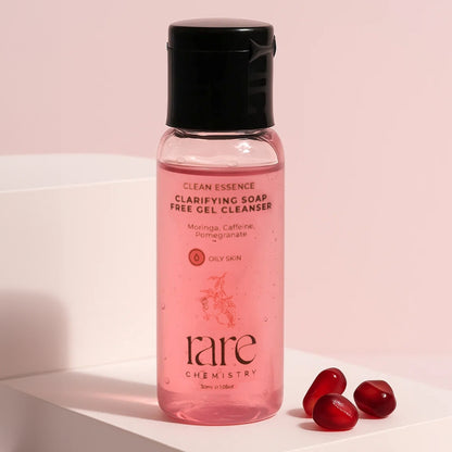 Pink bottle of 'rare chemistry' cleanser with black cap on a light pink background