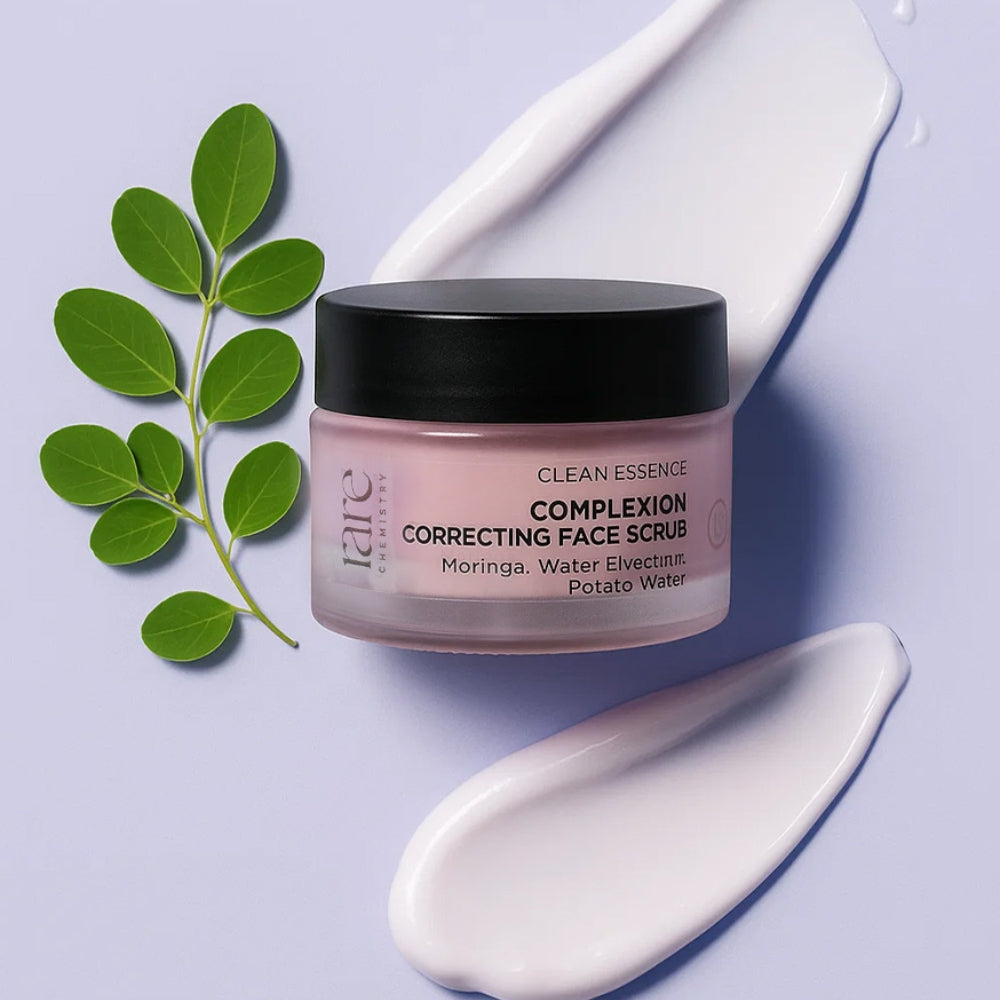 Jar of 'Clean Essence Complexion Correcting Face Scrub' with green leaves on a light purple background