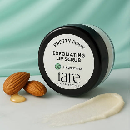 Exfoliating lip scrub container with almonds on a light background