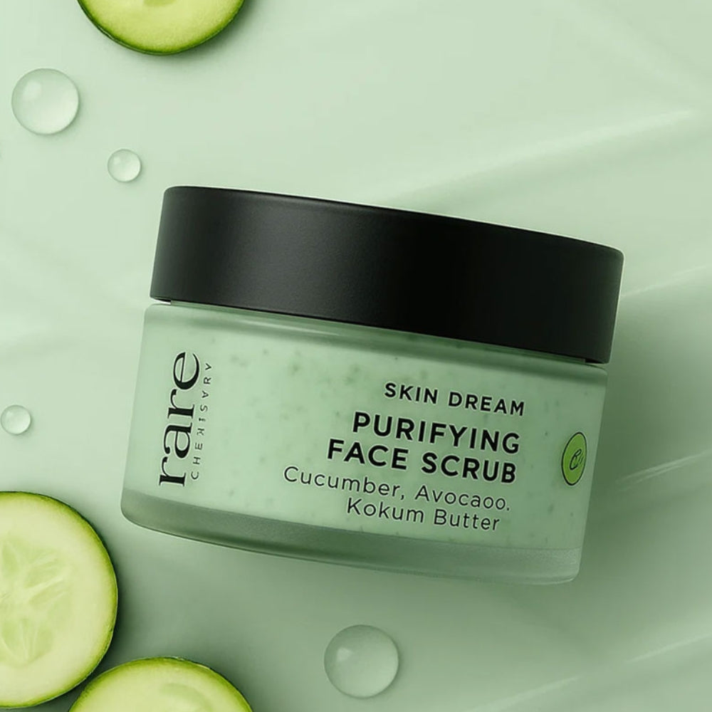 Jar of 'Skin Dream Purifying Face Scrub' with cucumber slices on a light green background